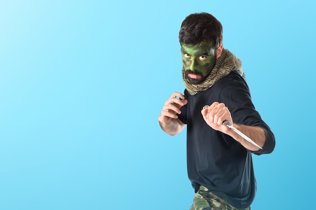 Soldier with knife  on colorful background