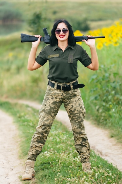 Soldier woman in military uniform A girl in a military uniform with a weapon