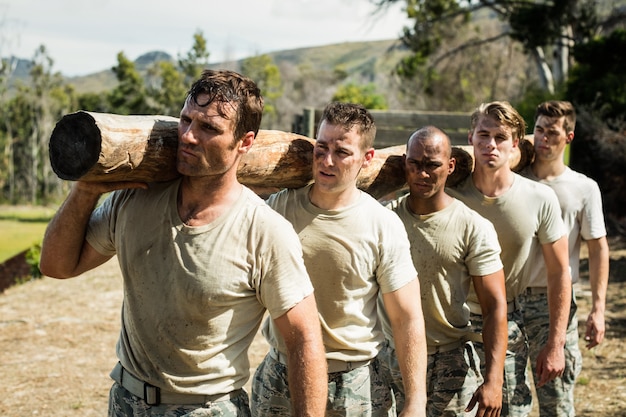 Soldiers carrying a tree log