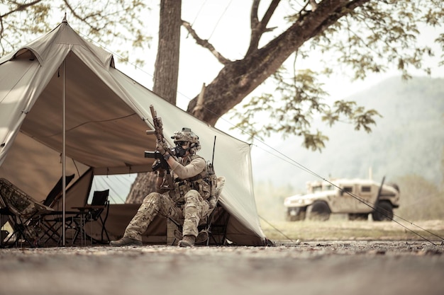 写真 キャンプでの作戦を計画するカモフラージュのユニフォームを着た兵士たち