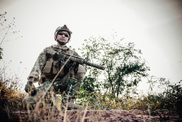 The soldiers pointed a gun at the enemyselective focus