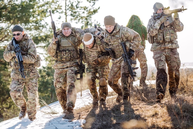 Soldiers with weapons during the rescue operation war army technology and people concept