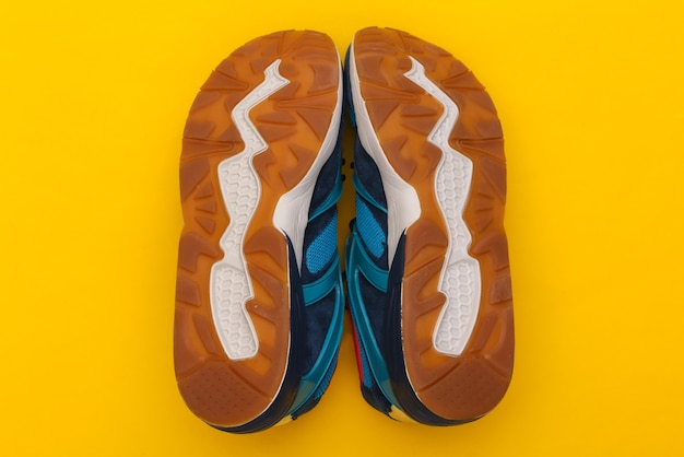 Sole sports shoes (sneakers) on a yellow background. Healthy lifestyle. Top view