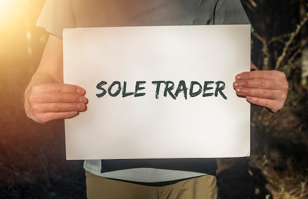 Sole trader text on paper in hands