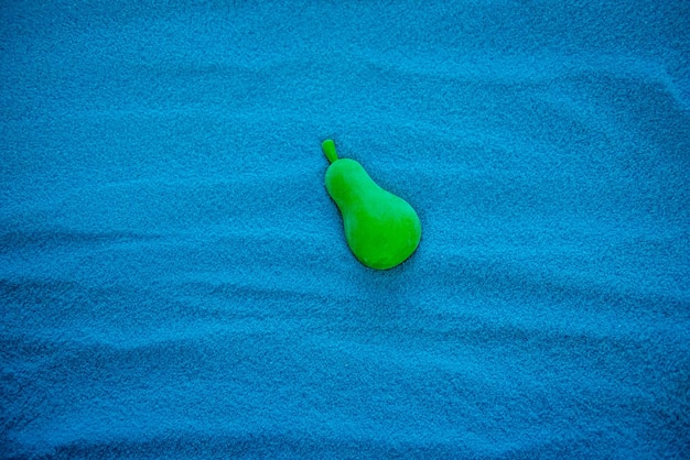 Solid blue sand with different patterns Blue turquoise color Green pear in the sand