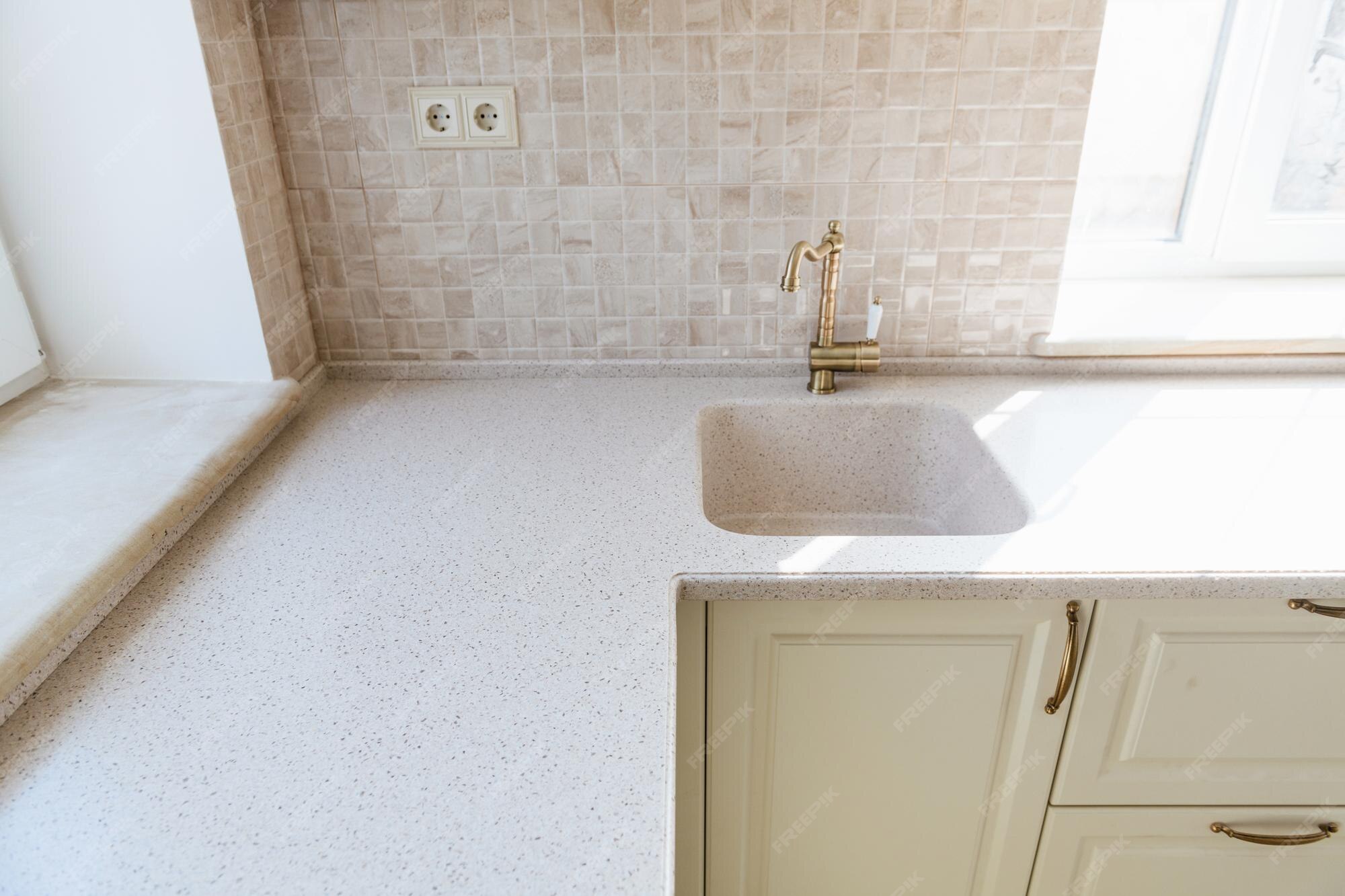 Premium Photo | Solid light marble countertop in the new white kitchen
