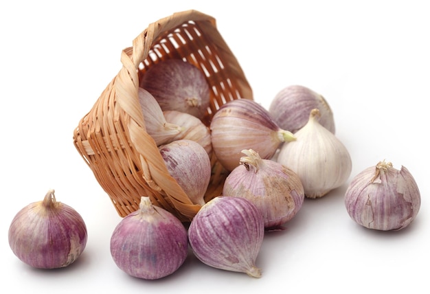 Solo or single clove garlic in a basket over white background