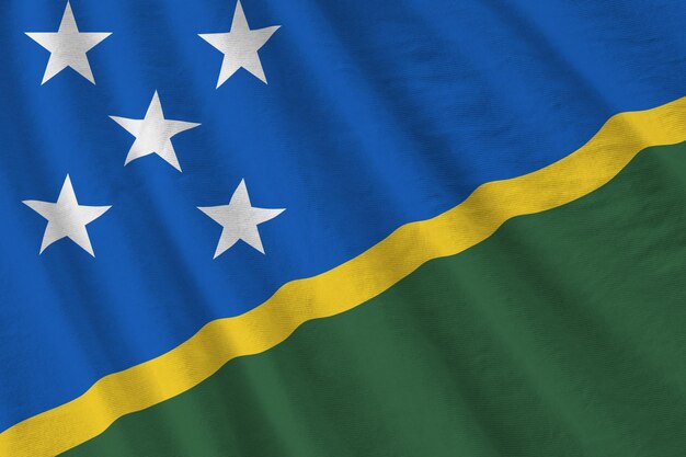 Photo solomon islands flag with big folds waving close up under the studio light indoors the official symb