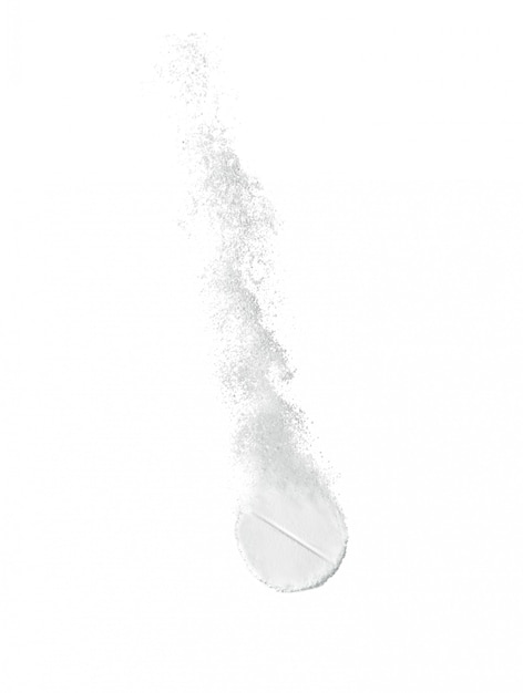 Soluble tablet in water on white surface