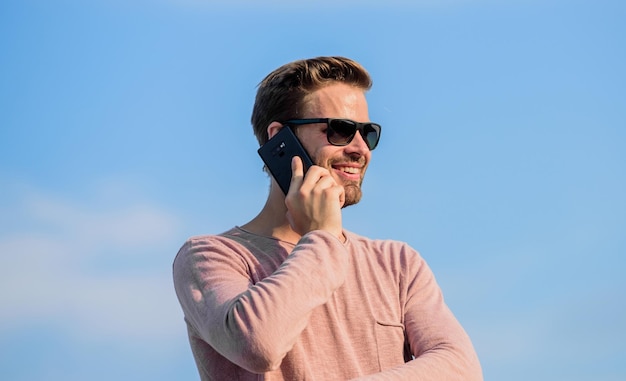 Solve cases by phone guy casual style Fashion model sexy man sky background macho man use mobile phone modern technology in life always in touch confident man speak on phone Call to friend