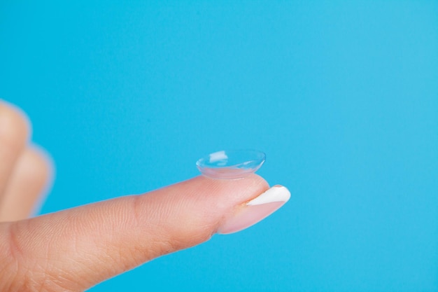 Solving vision problems close up of woman holding contact lens