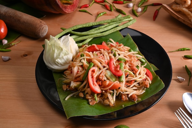 Som tum or green papaya salad in plate .Thai Food Concept.