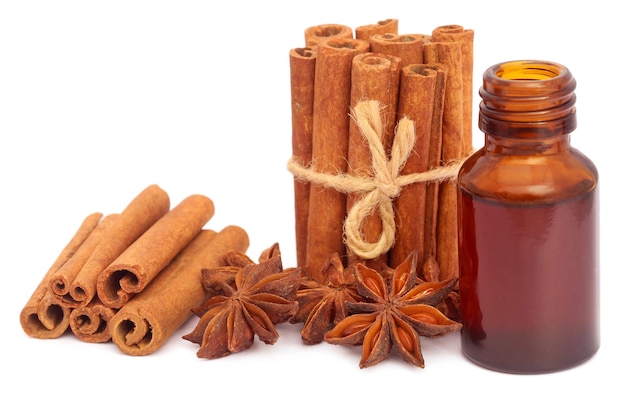 Some aromatic cinnamon with star anise and essential oil in a bottle