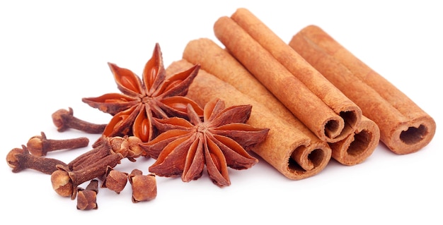 Some aromatic cinnamon with star anise over white background