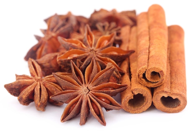 Some aromatic cinnamon with star anise over white background