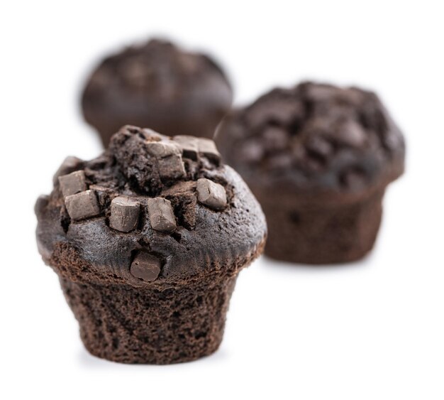 Some Chocolate Muffins isolated on white selective focus