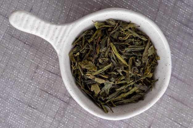 Some dry black tea in a bowl.