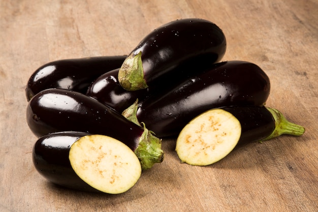 Some eggplants over a wooden surface. Fresh vegetable.