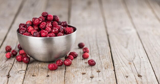 Some fresh Dried Cranberries on wooden background selective focus closeup shot