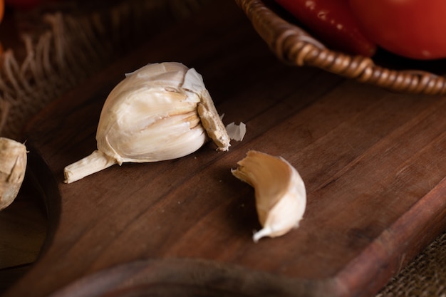 Some fresh garlics on wooden board