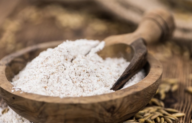 Some fresh Oat Flour on wooden background selective focus closeup shot