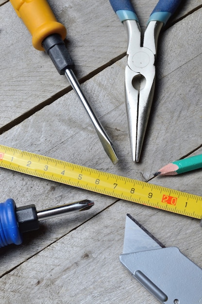 some home repair tools lie on a wooden background. close-up.