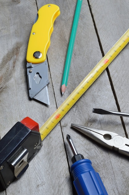 some home repair tools lie on a wooden background. close-up.