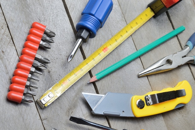 some home repair tools lie on a wooden background. close-up.