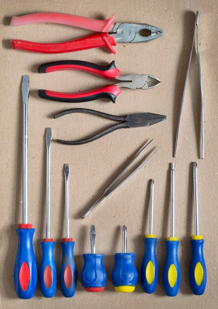 Some old hand work tools on cardboard background