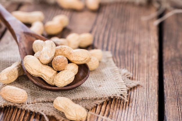 Some Peanuts on a wooden spoon