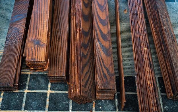 Some planks of wood stacked on the ground