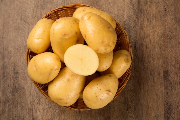 Some potatoes over a wooden surface. Fresh vegetable.