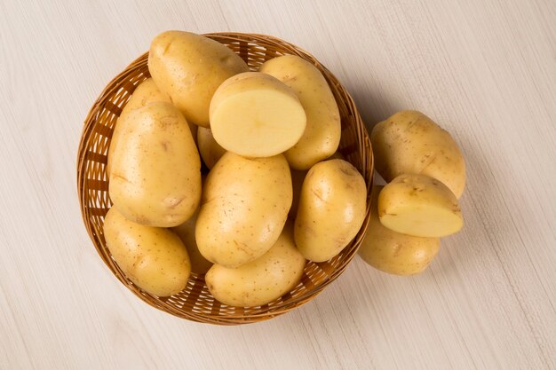 Some potatoes over a wooden surface. Fresh vegetable.