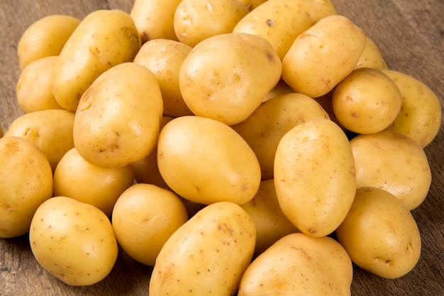 Some potatoes over a wooden surface. Fresh vegetable.