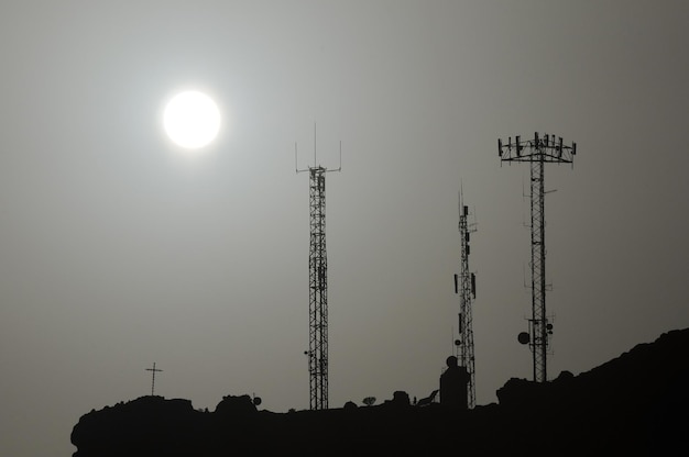 Some Silhouetted Antennas on the top of a Hill