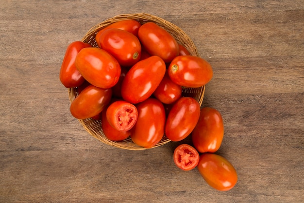 Some tomatoes over a wooden table. Fresh vegetable.