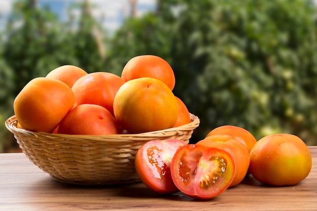 Some tomatoes over a wooden table. Fresh vegetable.