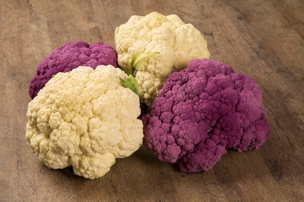 Some white cauliflowers over a wooden surface seen from above. Fresh vegetable.