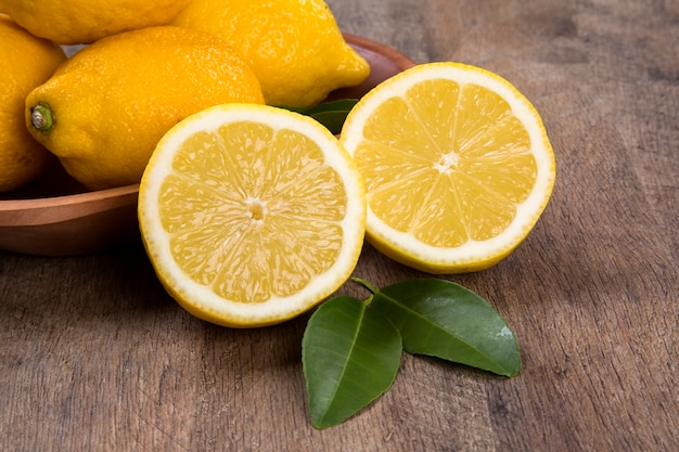 Some yellow lemons over a wooden surface. Fresh fruits