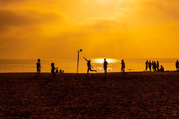 Some young people playing volleyball on the beach of San Miguel in the city of Almeria, Andalusia. Spain. Costa del sol in the mediterranean sea