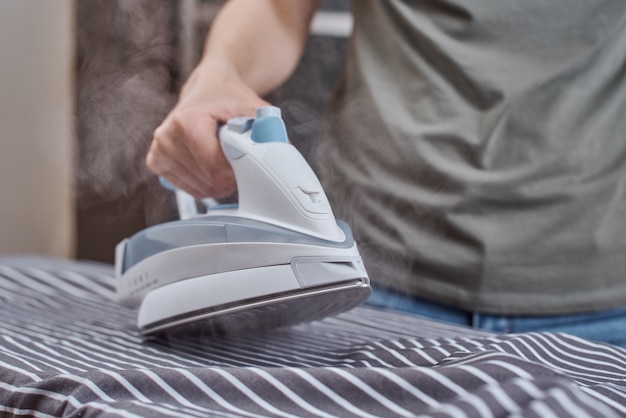 Someone is ironing clothes with an iron