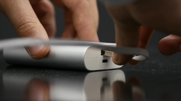Кто-то подключает кабель к USB-банку питания