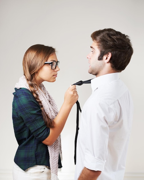 Someones in trouble An angry hipster woman holding her boyfriend by the tie