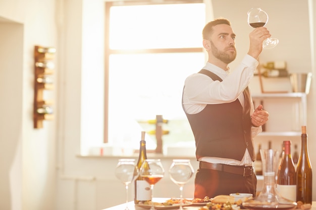 Sommelier Evaluating Wine