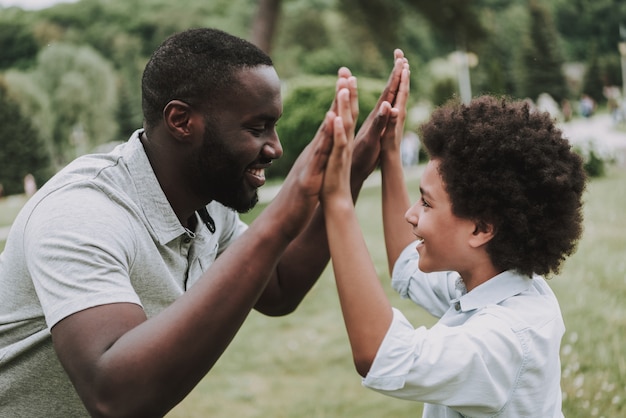 Son and Dad Looking on Each Other and Give Five