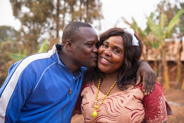 Son gives a kiss on the cheek of mother African mother and son concept of mother39s day