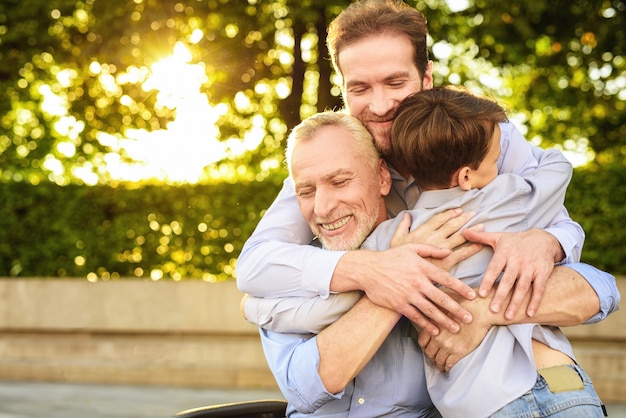 Son Grandson and Old Man Hugs Family Meeting