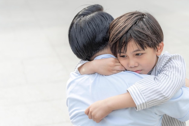 the son hugged his father fill sadly single dad and son happiness asian family concept