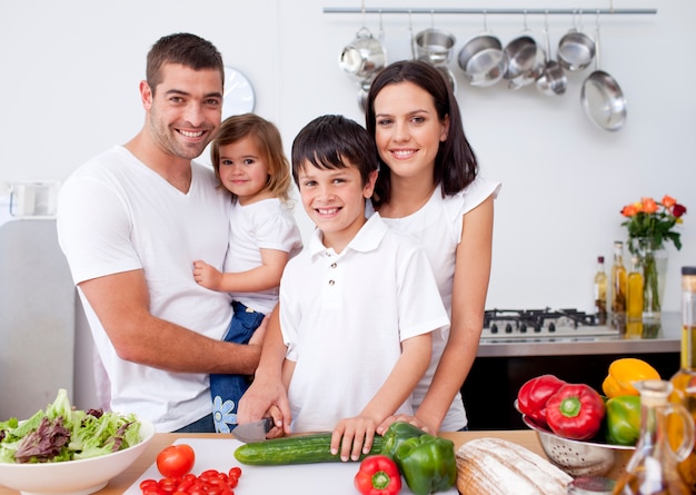 Son preparing food with his family