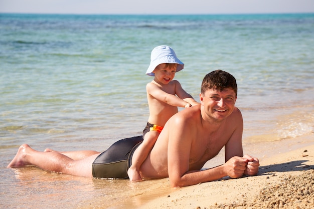 Son sit astride a father